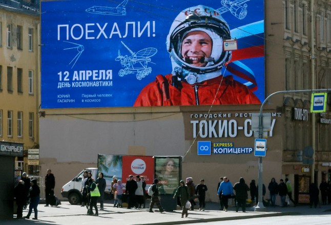 epa12018031 People walk past a digital billboard with an image of the world's first cosmonaut Yuri Gagarin and the slogan 'Let's go!' on the eve of 'Cosmonautics Day' celebrations in St. Petersburg, Russia, 08 April 2025. Russia will celebrate 'Cosmonautics Day' on 12 April, marking the 64th anniversary of the first human space flight on 12 April 1961, by Soviet cosmonaut Yuri Gagarin. EPA/ANATOLY MALTSEV