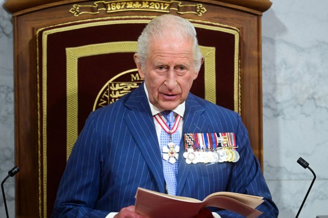Britain's King Charles III delivers a speech from the Throne to open the first session of the 45th Parliament of Canada at the Senate of Canada in Ottawa on May 27, 2025. Britain's King Charles III is heading to Canada for a brief but "impactful" visit, at a time when President Donald Trump is floating the idea of making his northern neighbour the 51st US state. The 76-year-old monarch, who is also Canada's head of state as part of the Commonwealth, has never publicly commented on the ambitions of the US president, a noted admirer of the royal family. (Photo by Victoria Jones / AFP) (Photo by VICTORIA JONES/AFP via Getty Images)